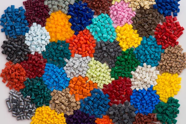 Heaps of dyed plastic granulate — Stock Photo, Image