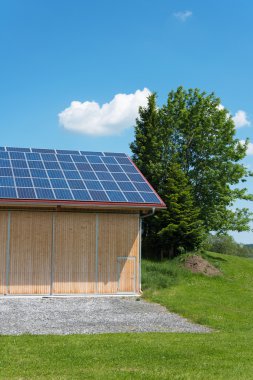 Solar power panels on roof of new barn clipart