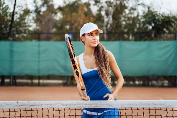 Fast play in the center of the court. Practicing short movements on the net. An active game of tennis on the orange clay tennis court. Clear, correct shoots of the coach.