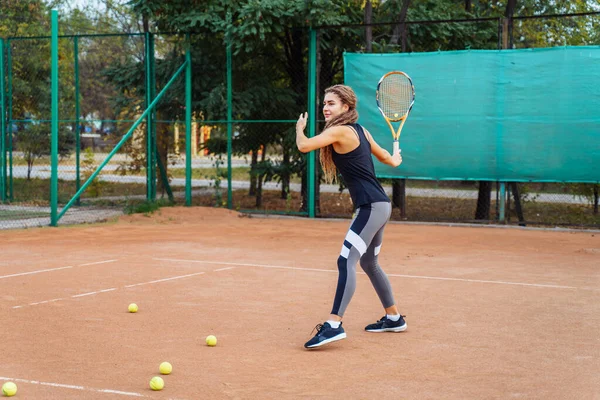 Woman tennis player is focused in a ready position. Athlete waiting for serve on a panoramic green background banner. Challenge and concentration in competition.