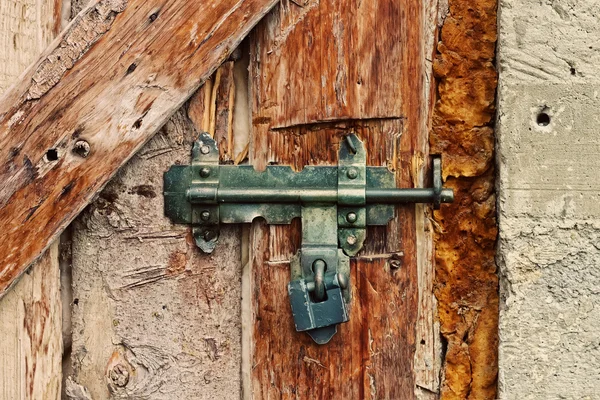 Latch with padlock on a old door — Stock Photo, Image