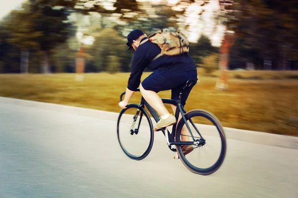 man riding on fixed gear bicycle