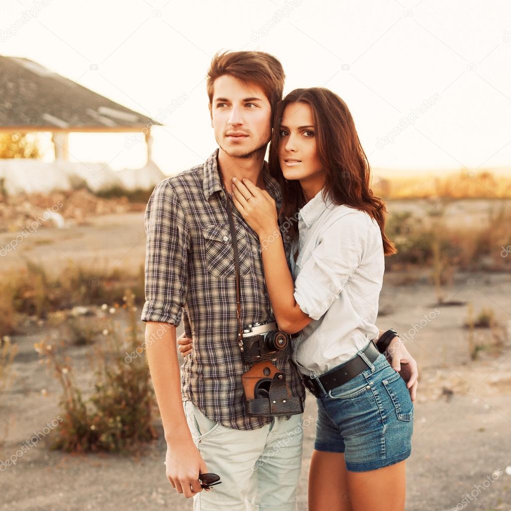 casual couple posing outdoor in sunset