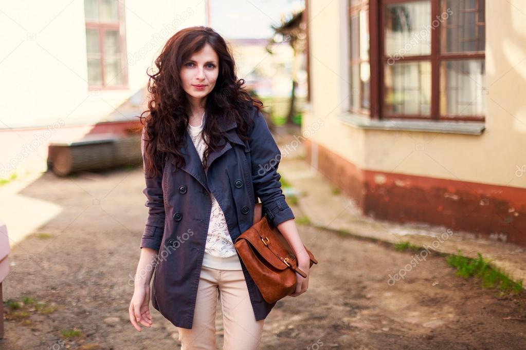 brunette woman posing in city