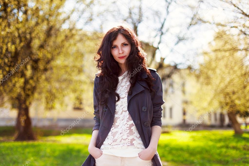 brunette woman posing in spring park