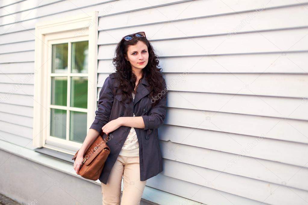 woman posing near house