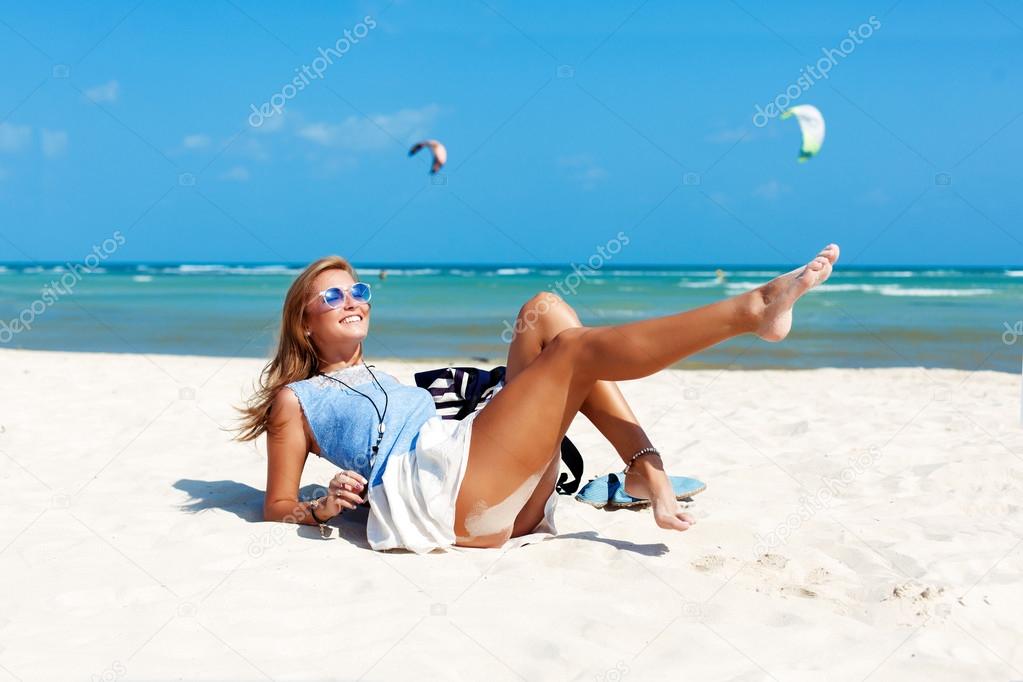 woman with sexy tanned legs on the beach