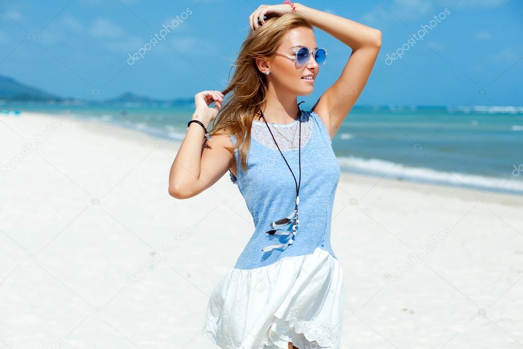 woman in blue dress posing on the beach