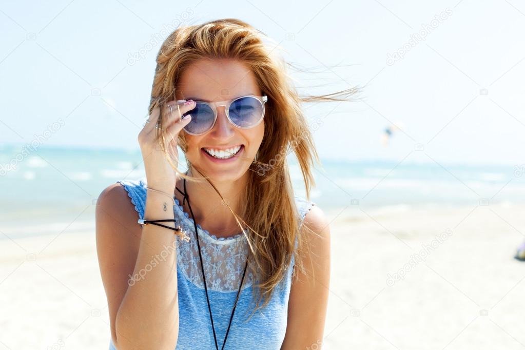blonde woman  in sunglasses on the beach