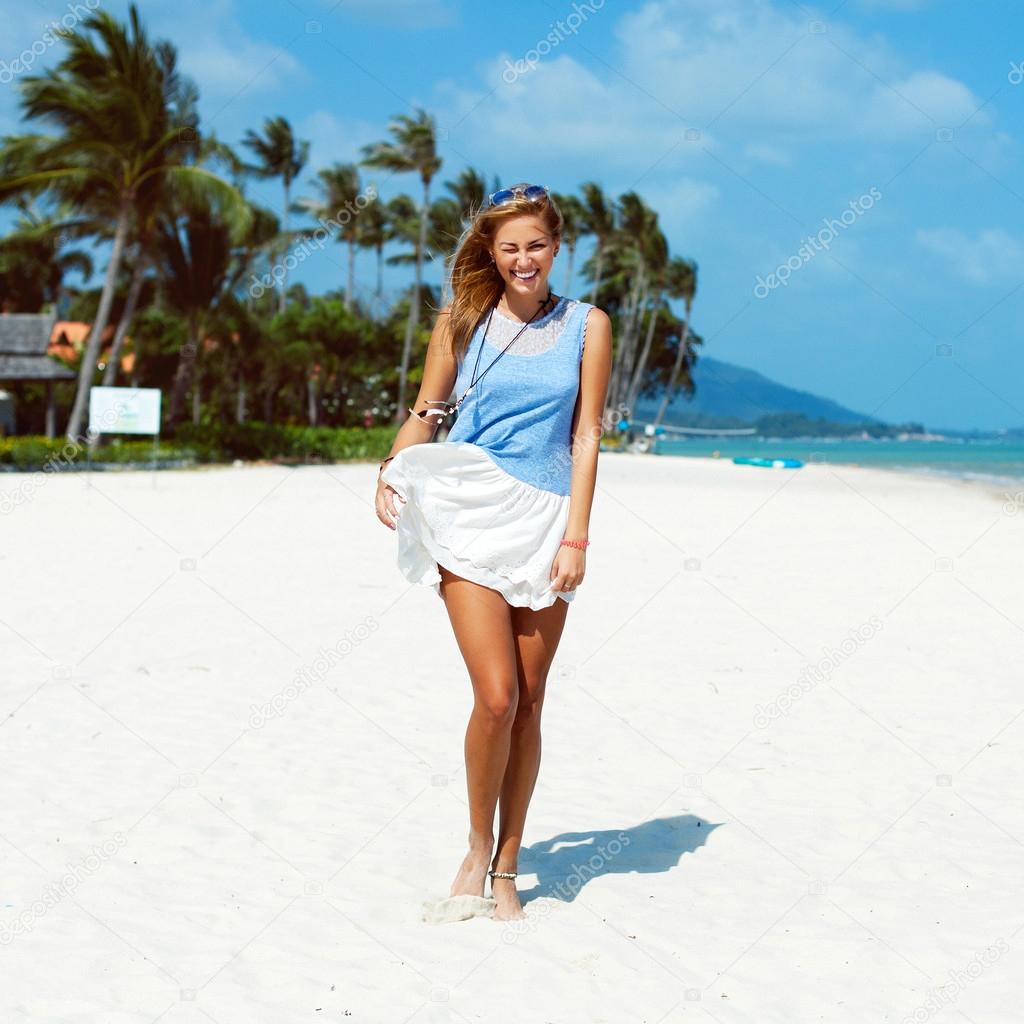 happy woman walking on the beach