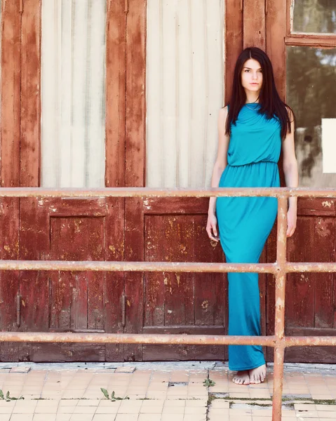 Young brunette woman in blue dress — Stock Photo, Image