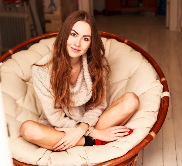 Femme assise sur un fauteuil rond à la maison — Photo