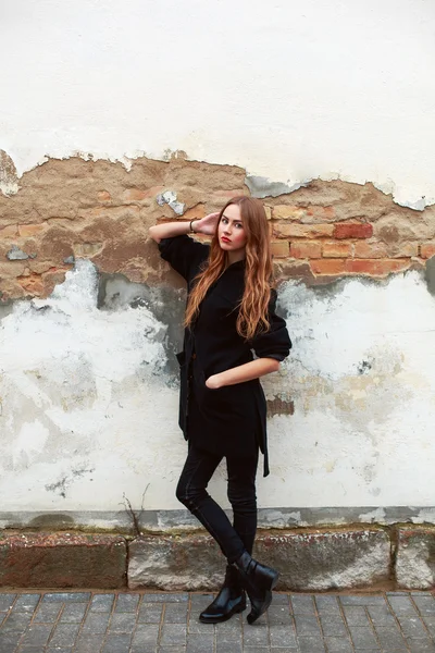 Femme en manteau près du vieux mur — Photo