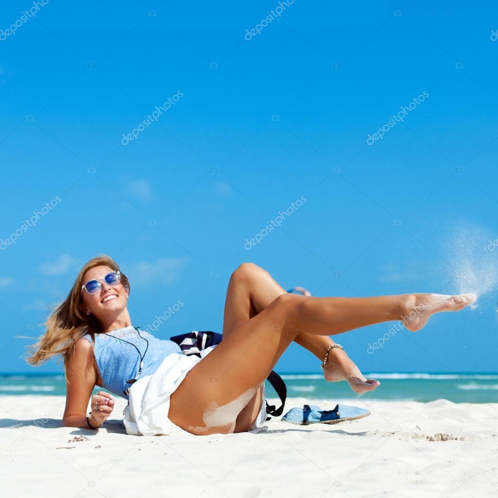 woman with sexy tanned legs on the beach