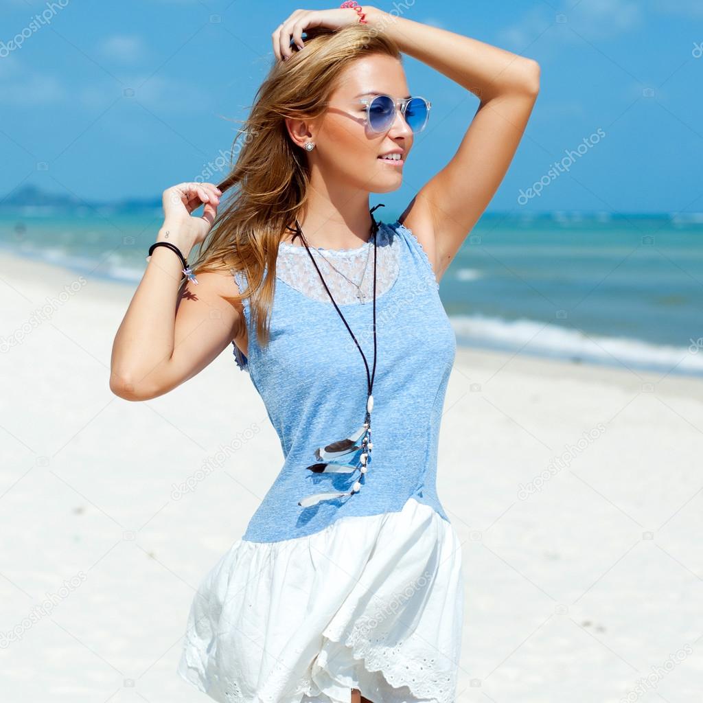 woman in blue dress posing on the beach