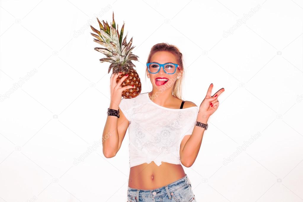 woman in glasses with pineapple showing tongue