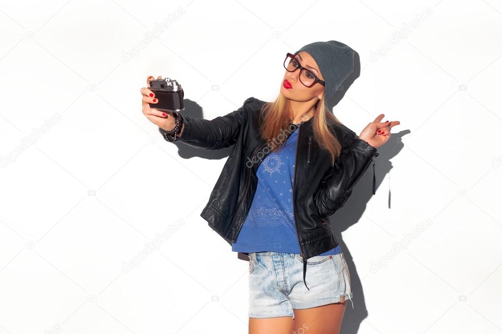 woman making selfie with vintage camera