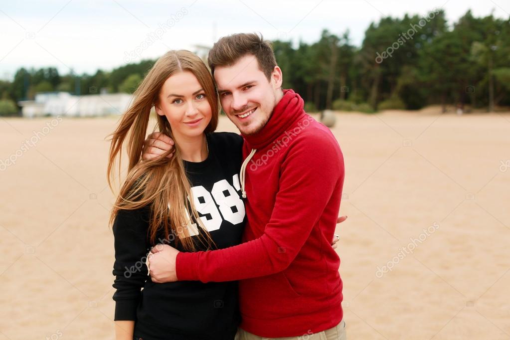 young couple in love posing on the beach