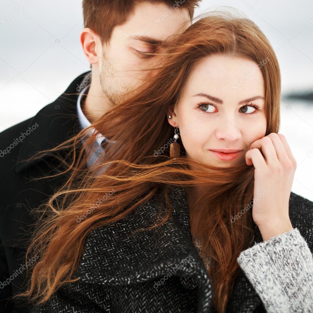 young couple posing in winter