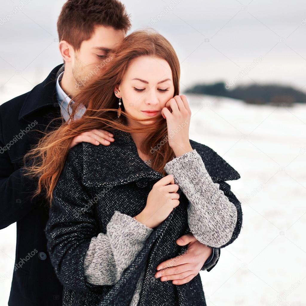 young  couple in love at windy winter