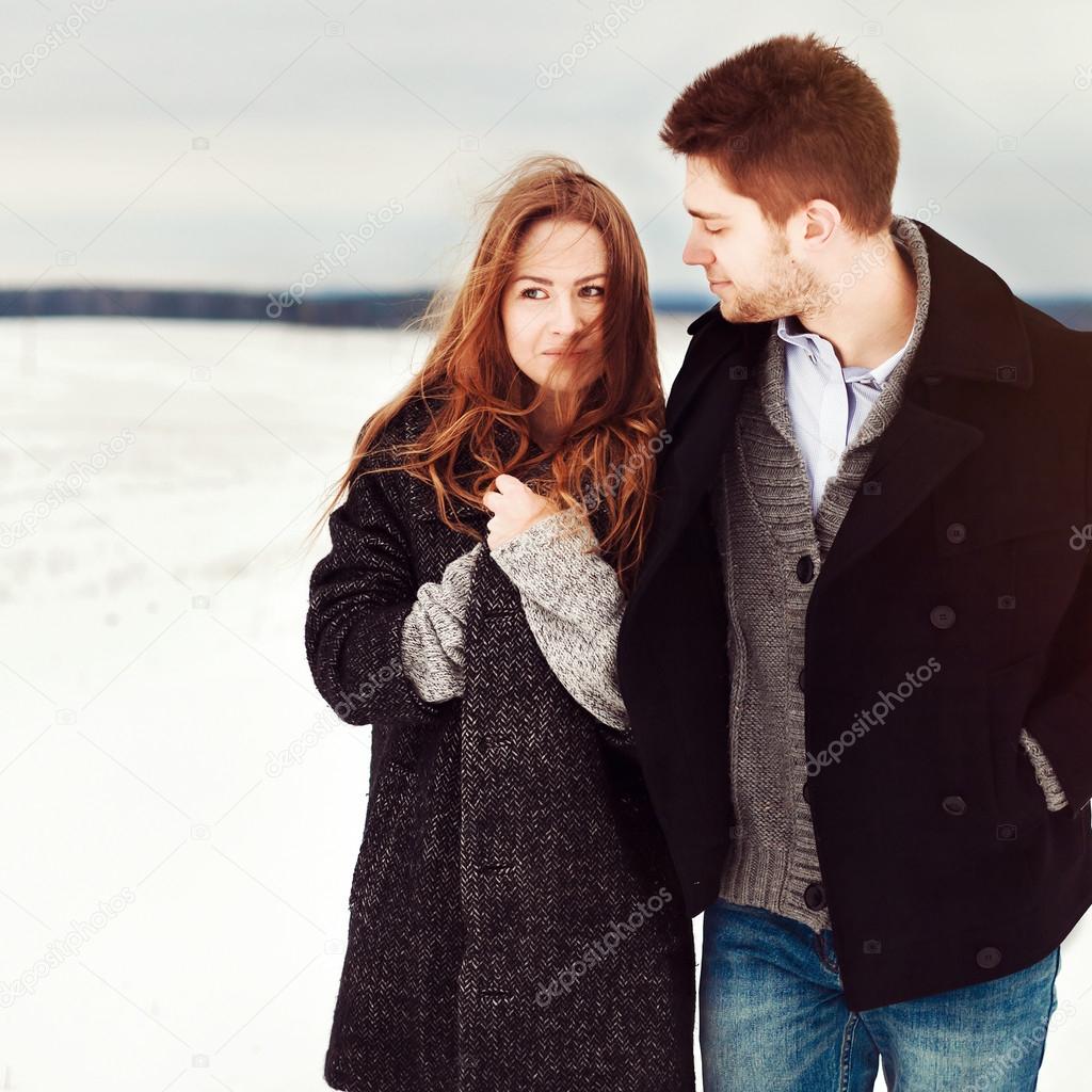 Young couple walking in winter field
