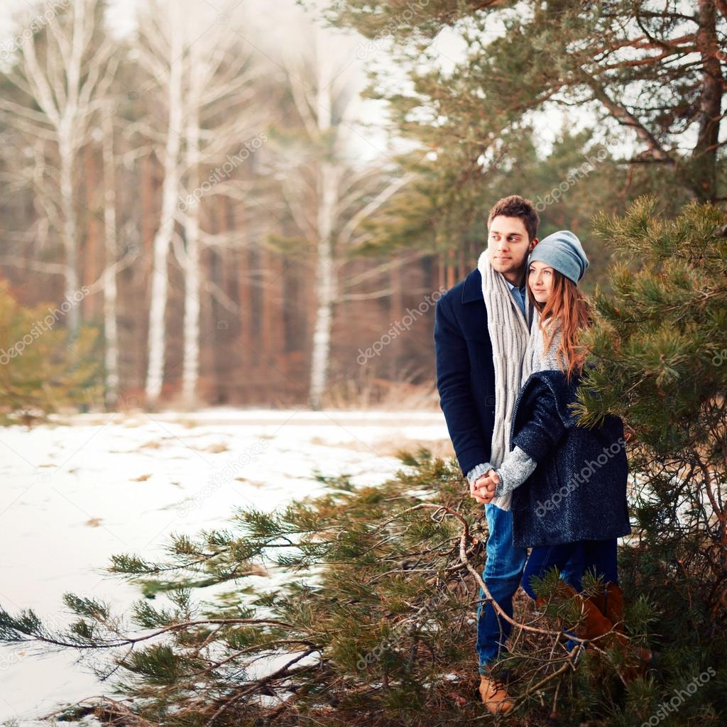 fashion couple posing in winter forest
