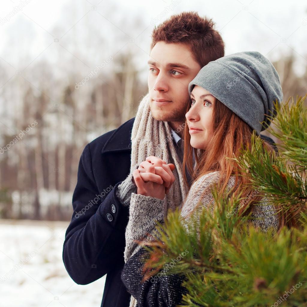 happy couple posing in winter forest