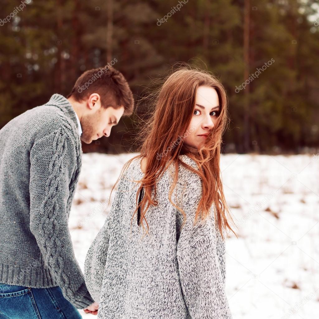 couple in love walking in winter forest