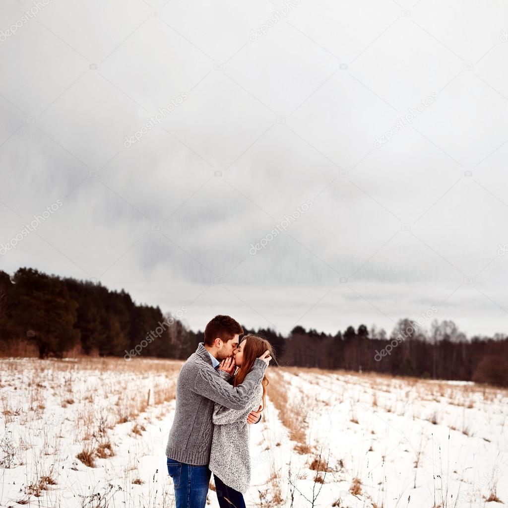 Boy and girl kissing in winter