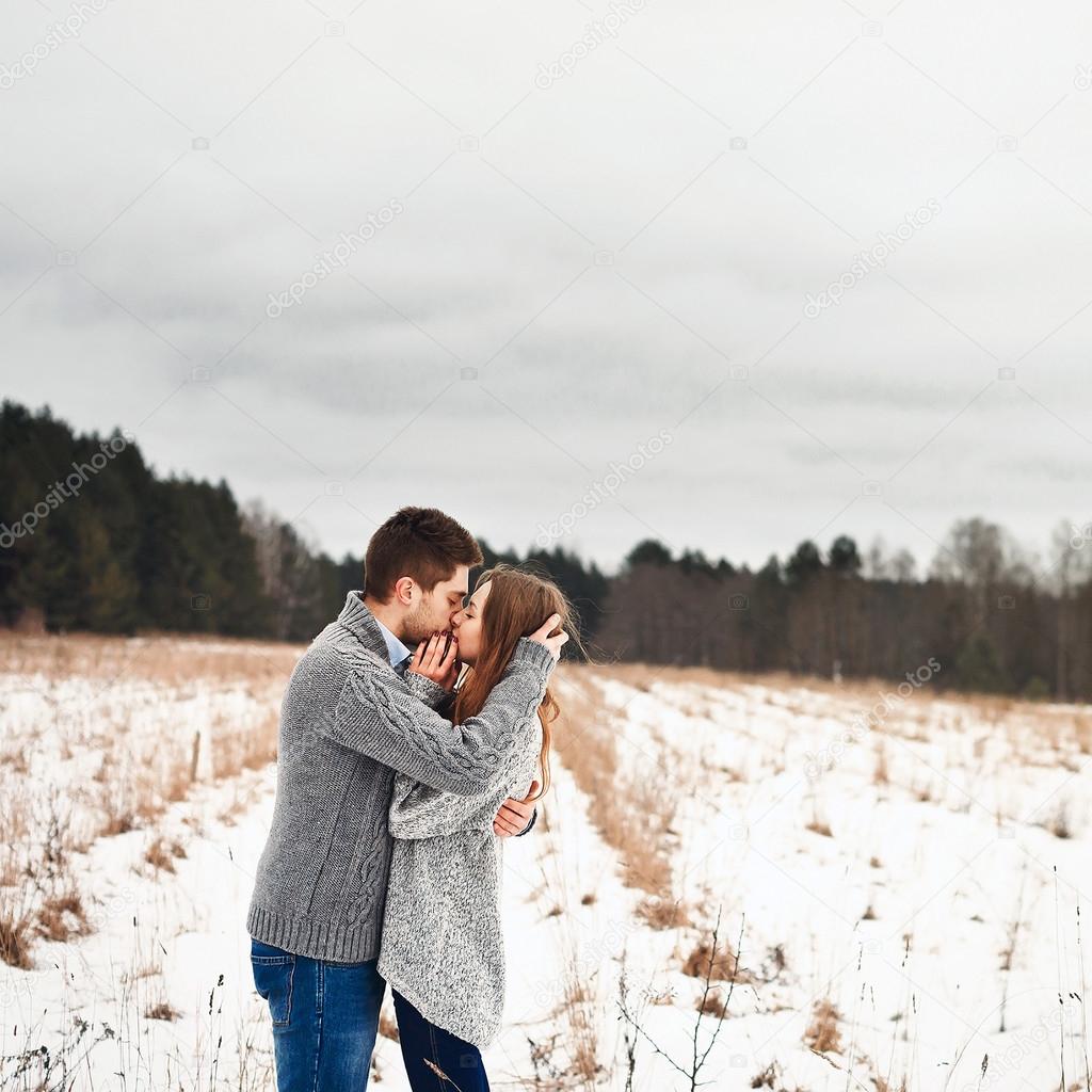 Boy and girl kissing in winter