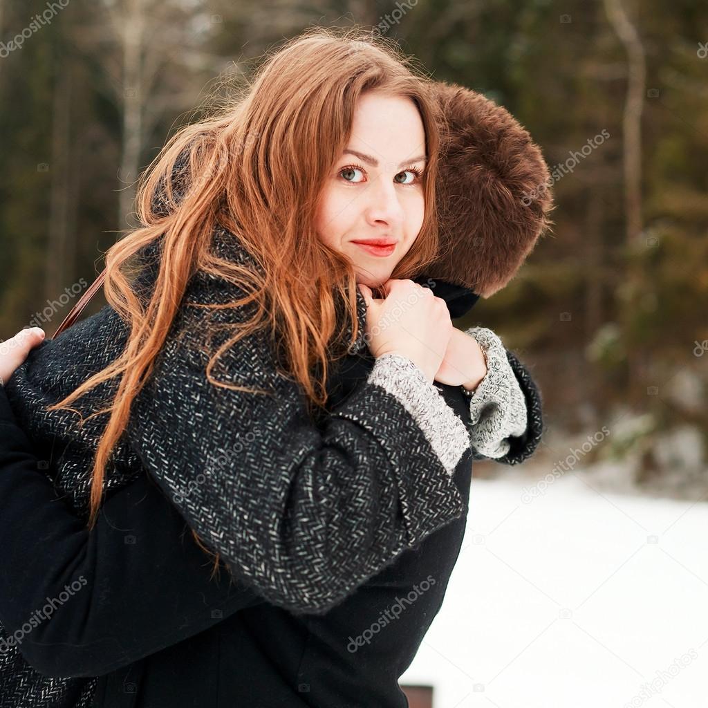 woman hugs her boyfriend in winter