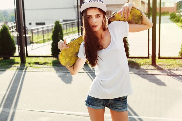 Girl with skateboard in summer time — Stock Fotó