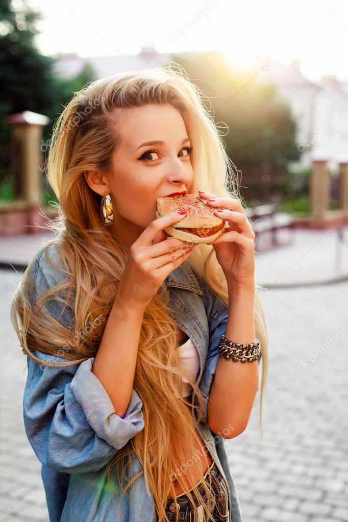 funny woman eating hamburger