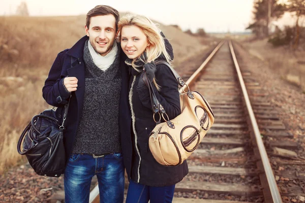 Girl and man posing on rail road — Stock Photo, Image