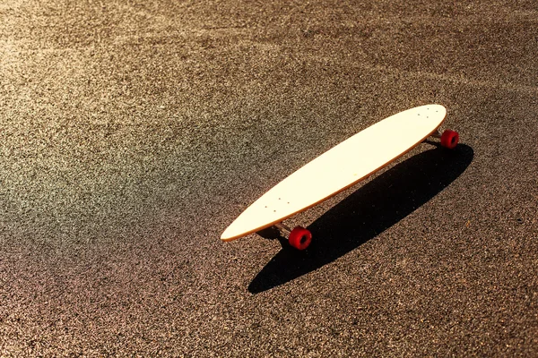 Longboard on asphalt road — Stock Photo, Image