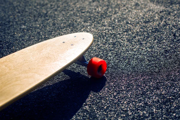 Longboard on asphalt road — Stock Photo, Image