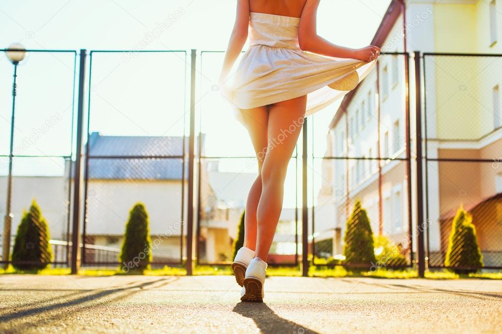 blonde woman walking on the street