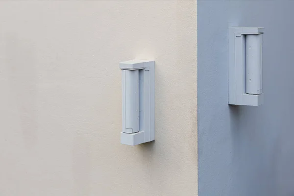 Burglar alarm sensors are mounted on the outer wall of the house.