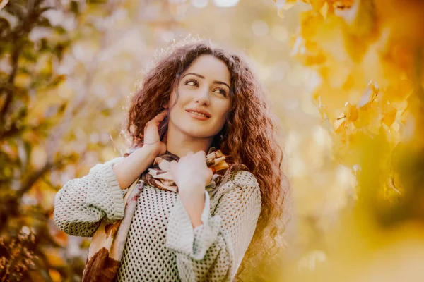 Gülümseyen kıvırcık saçlı kızın renkli sonbahar portresi 