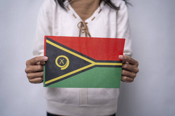Person Holding Vanuatu National Flag Against Neutral Background