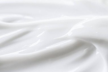 Soyut arkaplan, gıda maddesi veya organik kozmetik olarak saf beyaz krem dokusu
