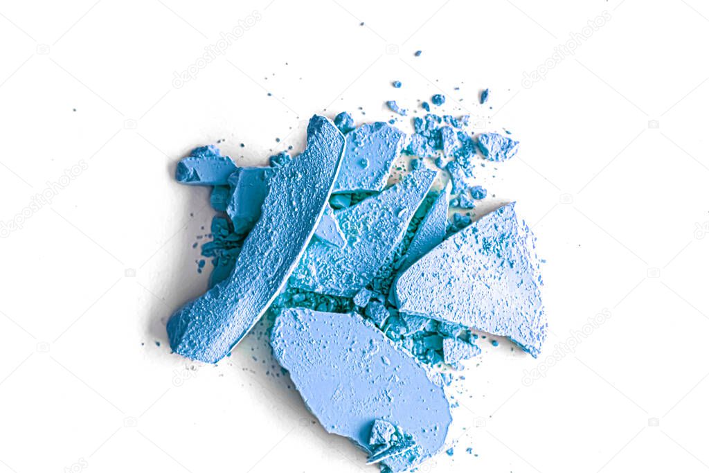 Blue eye shadow powder as makeup palette closeup isolated on white background, crushed cosmetics and beauty texture