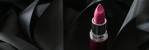 Pink lipstick on black silk background, luxury make-up and beauty cosmetic