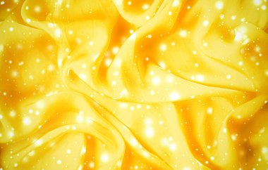 Sihirli bayram altın rengi yumuşak ipekten düz arkaplan dokusu parlayan kar, lüks güzellik soyut zemin