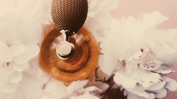 Vintage bottiglia di profumo con fiori di peonia, profumo chic fragranza come cosmetici di lusso, moda retrò e sfondo del prodotto di bellezza — Video Stock