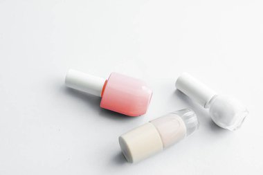 Beyaz arka planda tırnak cilası şişeleri, güzellik markası