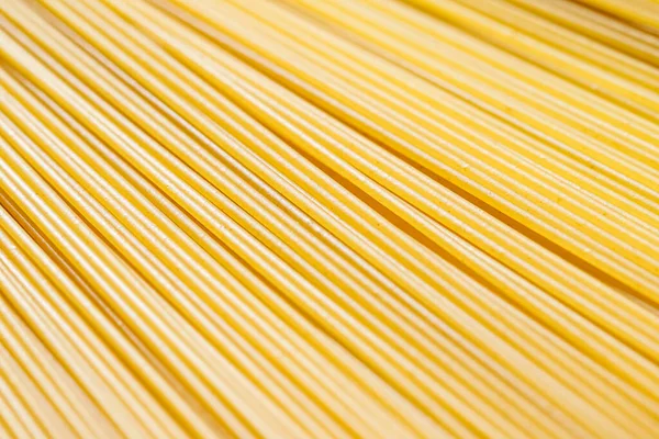 Неприготовленные спагетти из цельного зерна крупным планом, итальянская паста как органический пищевой ингредиент, макро-продукт и рецепт поваренной книги — стоковое фото