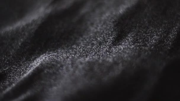 Textura de tela brillante negra de cerca para la marca de moda como fondo de brillo navideño, superficie textil y material de lujo — Vídeo de stock