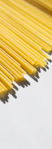 Uncooked whole grain spaghetti closeup, italian pasta as organic food ingredient, macro product and cook book recipe — Stock Photo, Image