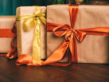 Hediye kutuları ve altın Noel ağacı, tatil evi dekorasyonu olarak köy tarzı hediyeler ve dekorlar.